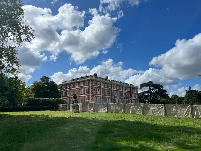 Image of Trent Park House from a distance with blue sky and clouds